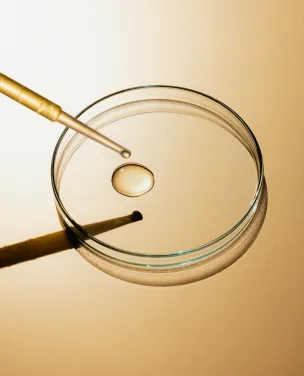 Dropper adding a liquid formula into a petri dish during formulation development