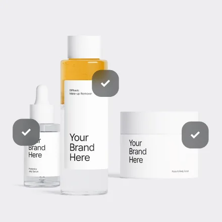 Lineup of skincare bottles and tubes with checkmark icons and 'Your Brand Here' placeholder labels