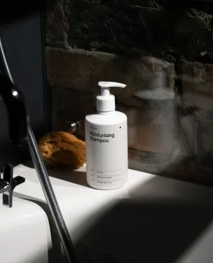 Pump bottle labeled 'Immunity Shampoo' displayed on a dark shelf