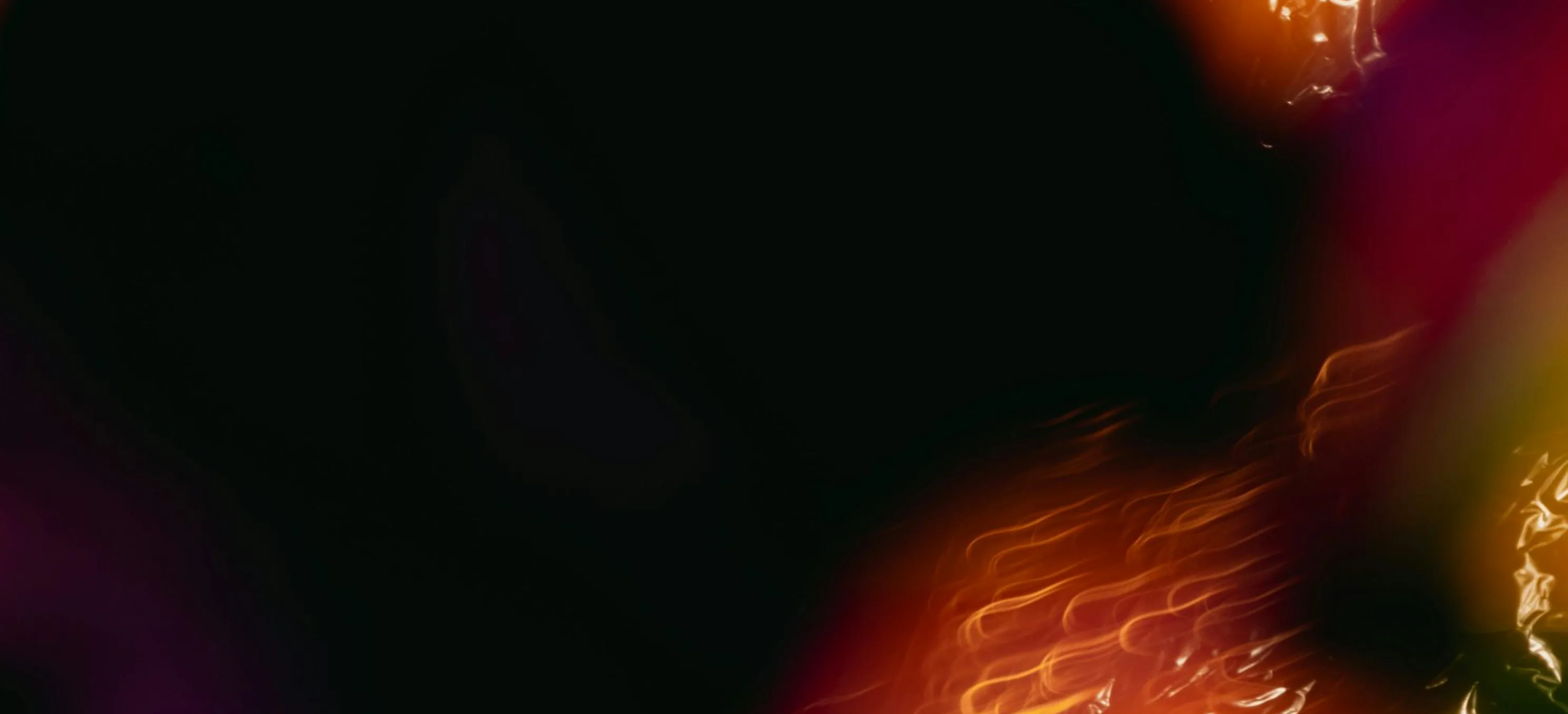 Dark abstract background with warm, fiery gradient light streaks