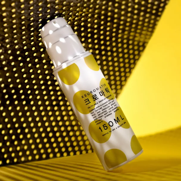 Private label skincare bottle with custom packaging and lettering on a yellow polka-dot background